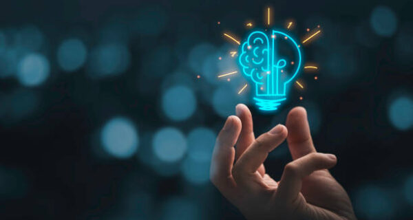 Hand holding drawing virtual lightbulb with brain on bokeh background for creative and smart thinking idea concep